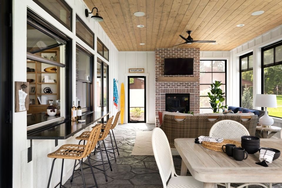 Outdoor entertaining space with wood ceiling and recessed lighting in lake home